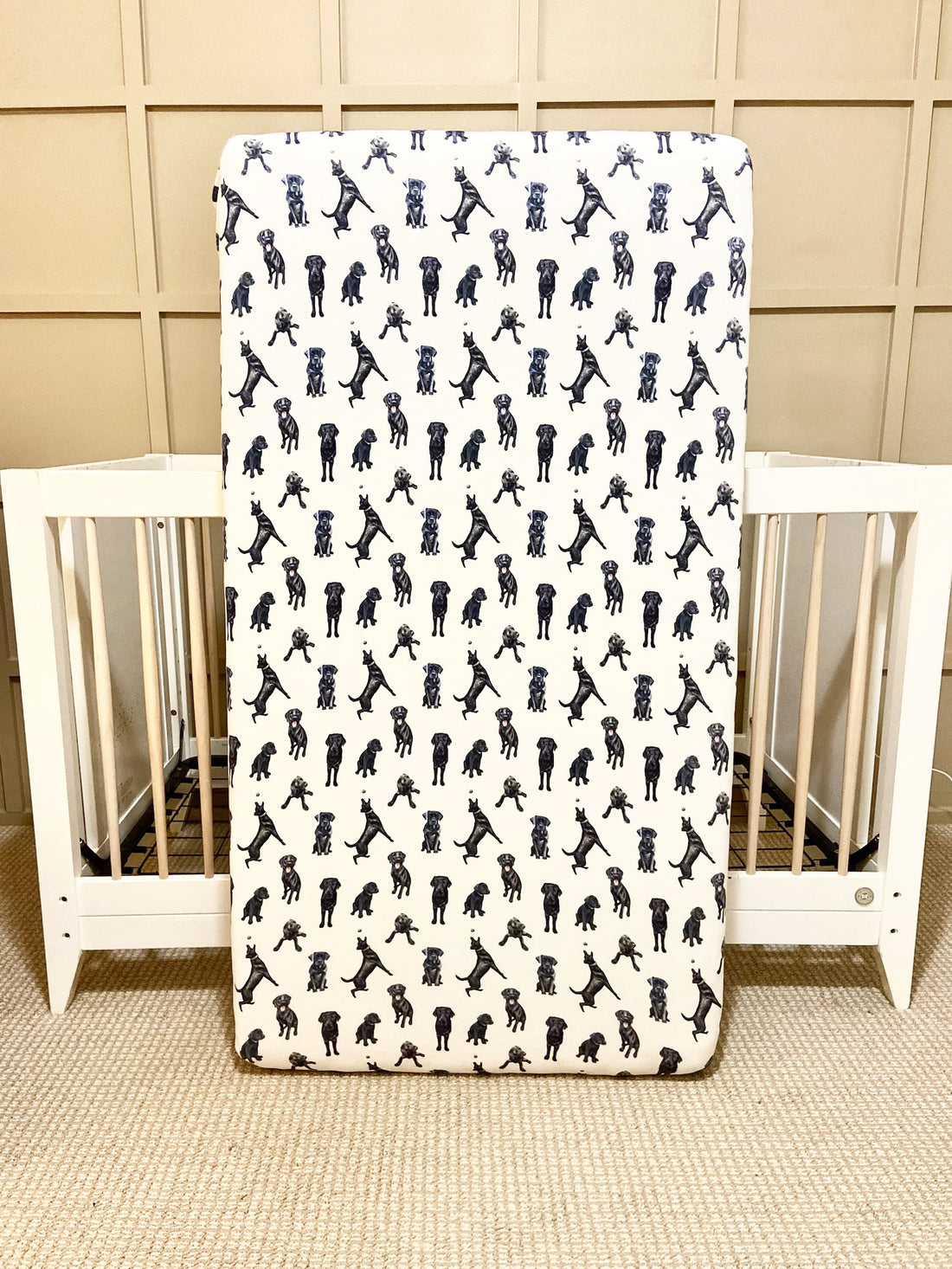 Fitted Black Lab crib sheet with adorable Labrador designs, crafted for durability and softness, perfect for both cribs and toddler beds.