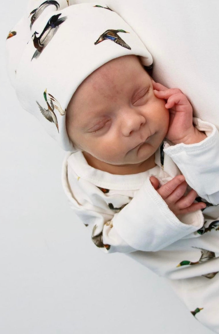 Newborn hat featuring a playful diving ducks print on a soft cotton fabric