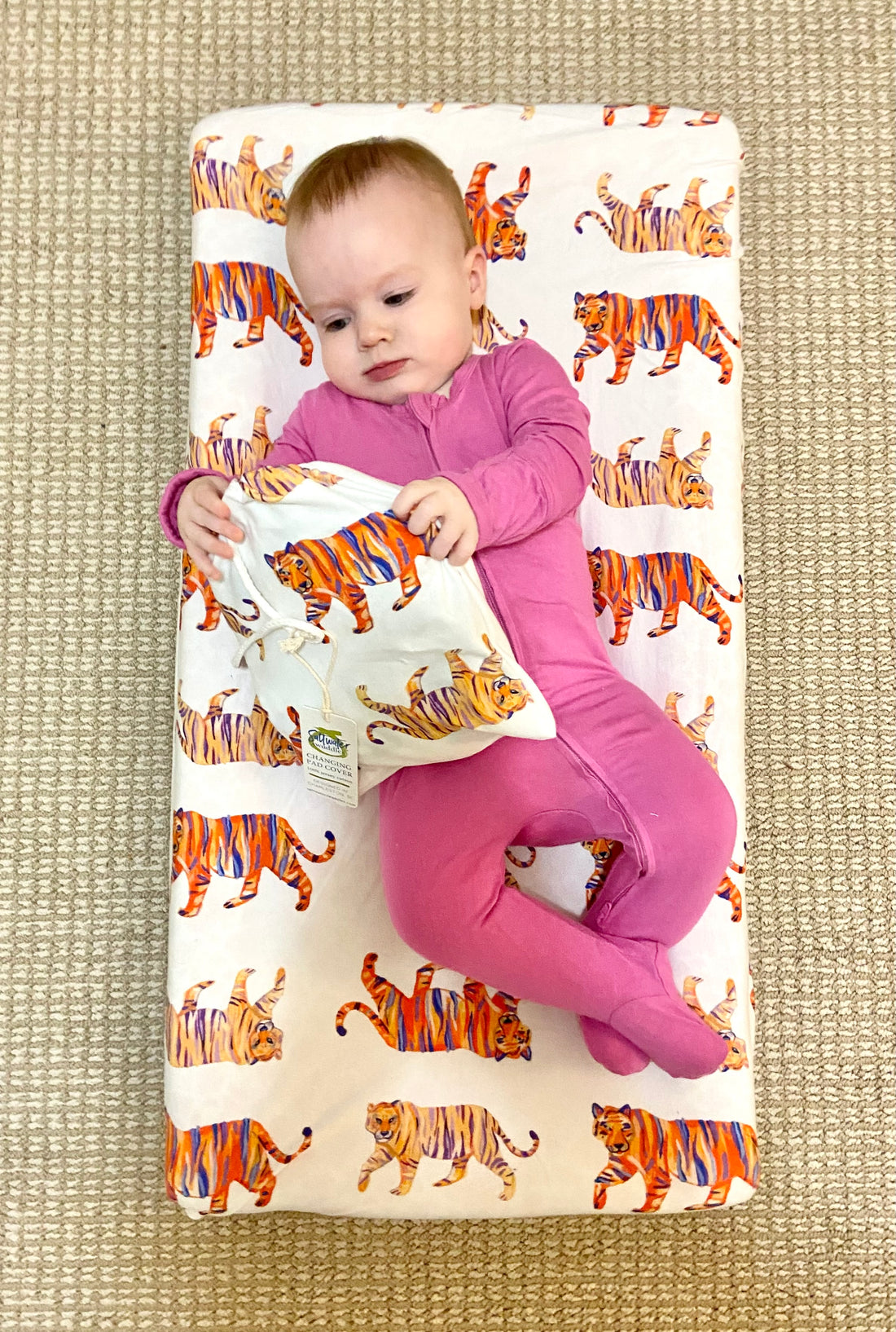 Baby changing pad with Easy Tiger print cover, perfect for jungle-themed nursery