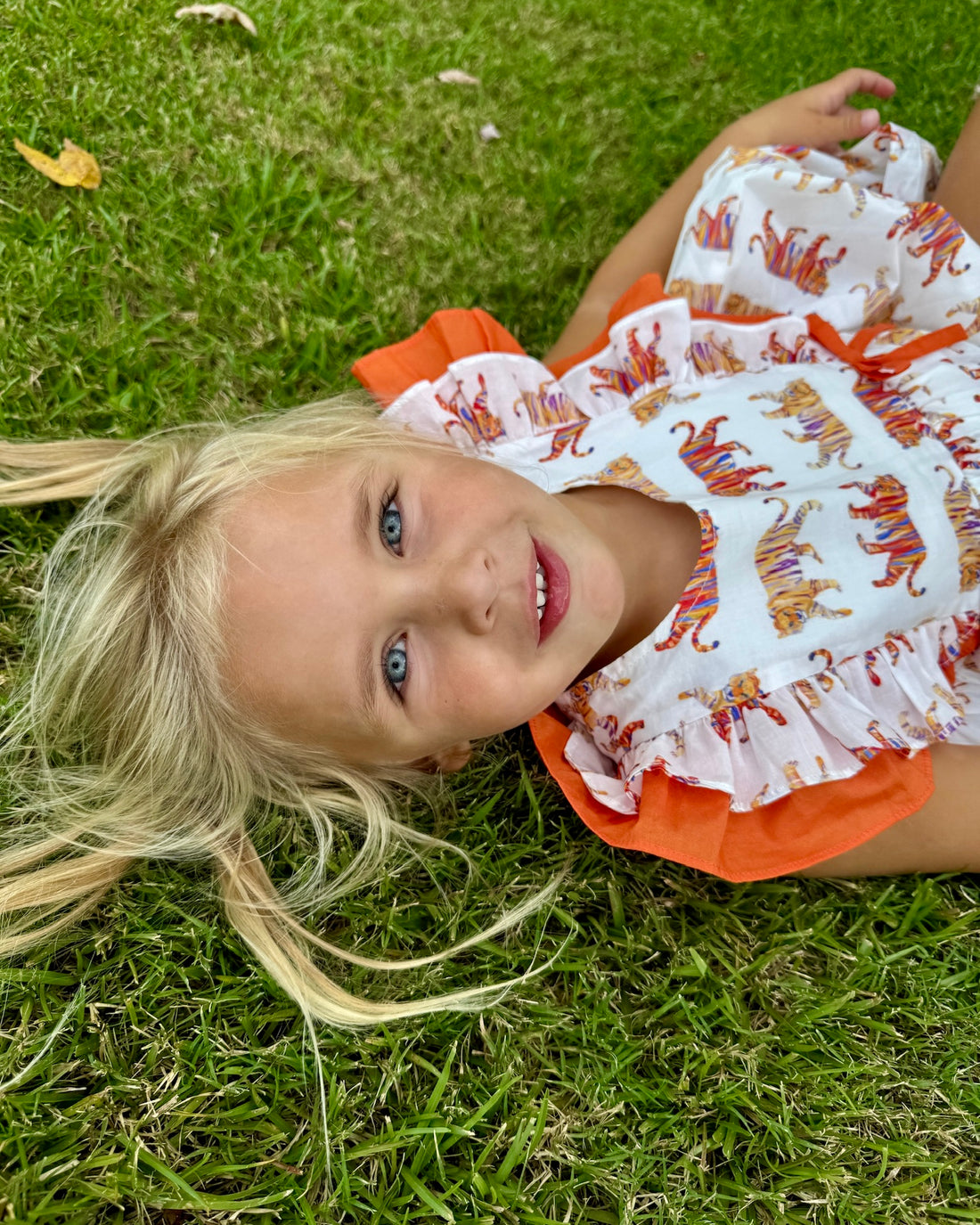 Easy Tiger Flutter Sleeve Dress captured in a playful outdoor setting, ideal for active kids and casual adventures.