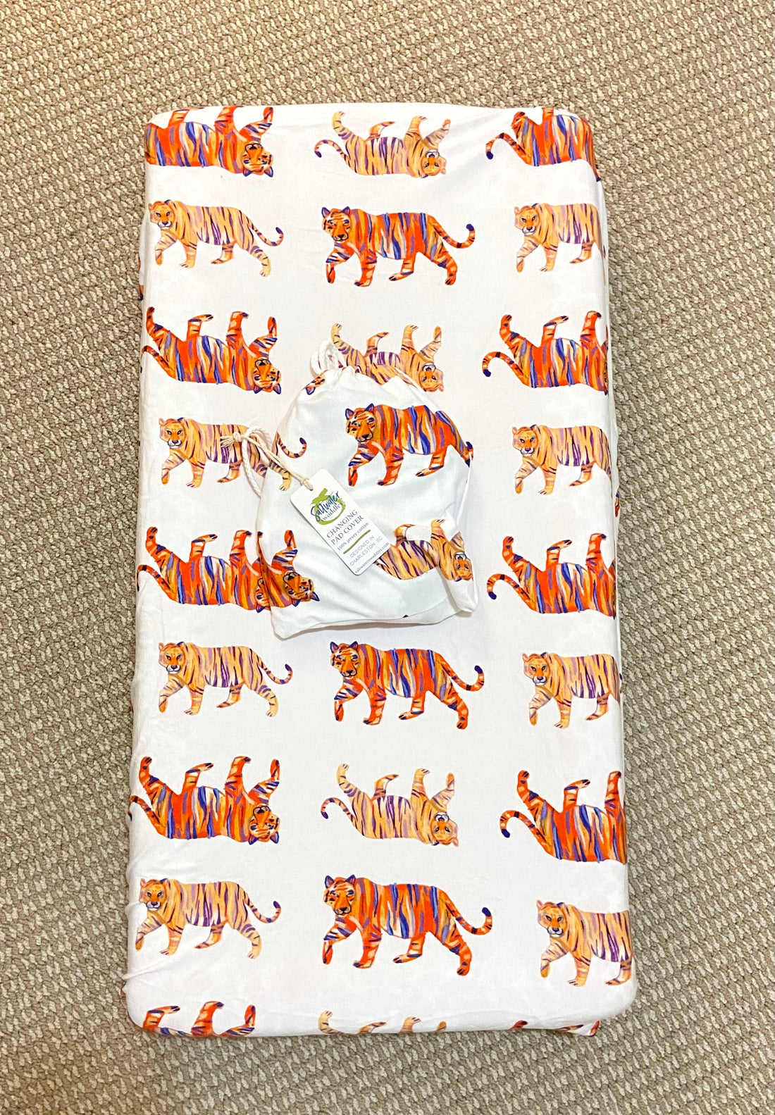 Baby changing pad with Easy Tiger print cover, perfect for jungle-themed nursery