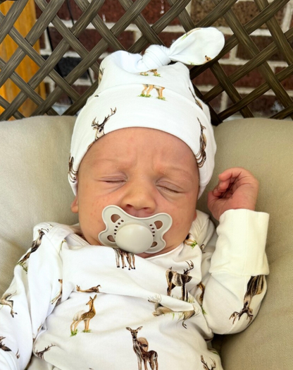 Newborn hat featuring a whimsical little fawn and big yawn deer print on soft fabric