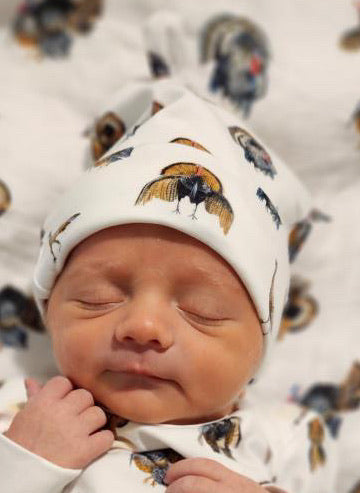 Newborn hat featuring a festive Turkey Trot print, perfect for celebrating the season